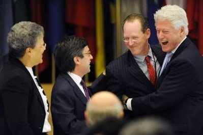 Paul Farmer (2nd R), co-founder of Partners In Health and board member of the Institute for Justice & Democracy in Haiti, laughs with former U.S. President Bill Clinton (R) at the Haiti Donors Conference at the Inter-American Development Bank in Washington, April 14, 2009. Also pictured are Inter-American Development Bank President Luis Alberto Moreno (2nd L) and Haiti's Prime Minister Michele Duvivier Pierre-Louis (L).